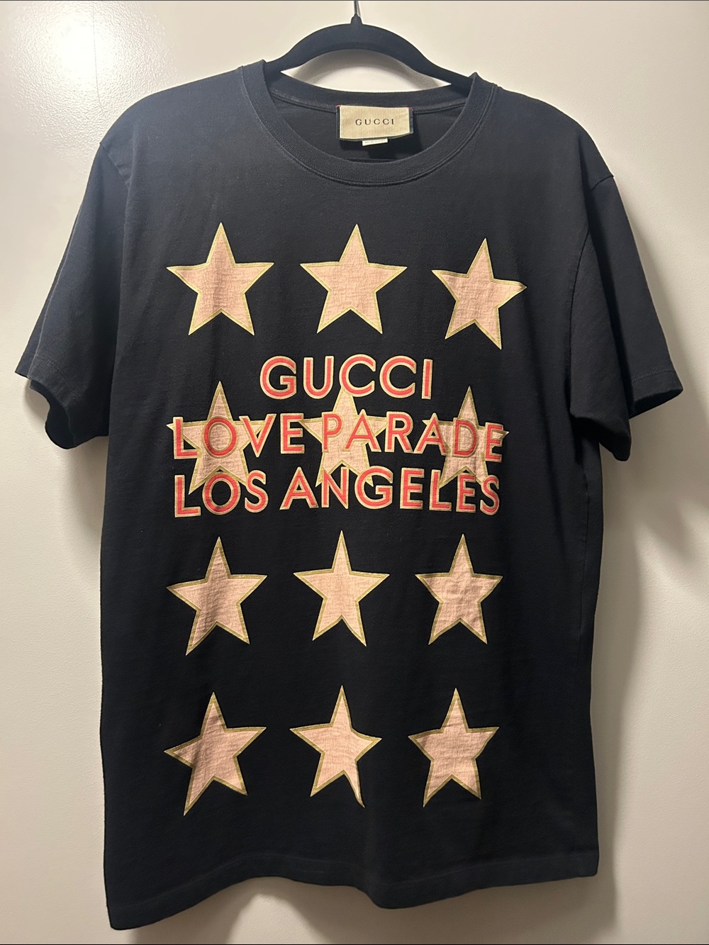 Gucci Black Tee with Pink Star Graphics and Red Lettering